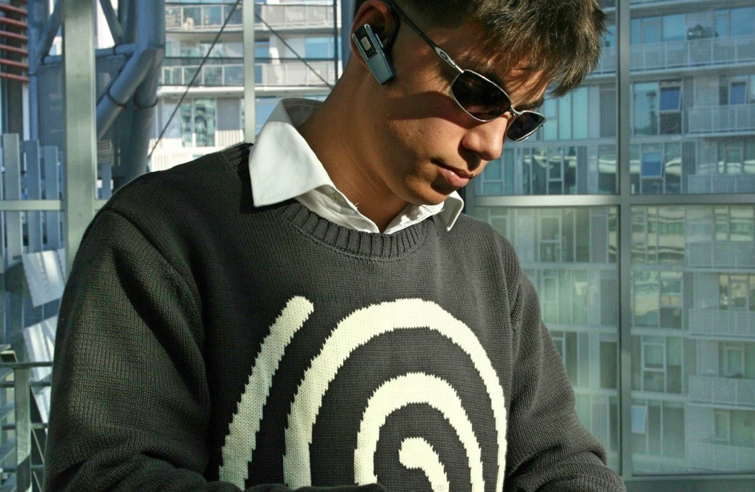 Close-up of Hypnotic Clothing Lost in the Matrix spiral sweater showing knit texture and spiral pattern, modern streetwear detail shot.