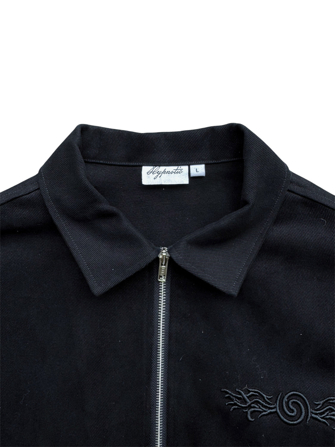 Close-up of the collar and neck tag on the Hypnotic Clothing Lucien black work jacket, detailed modern streetwear branding shot.