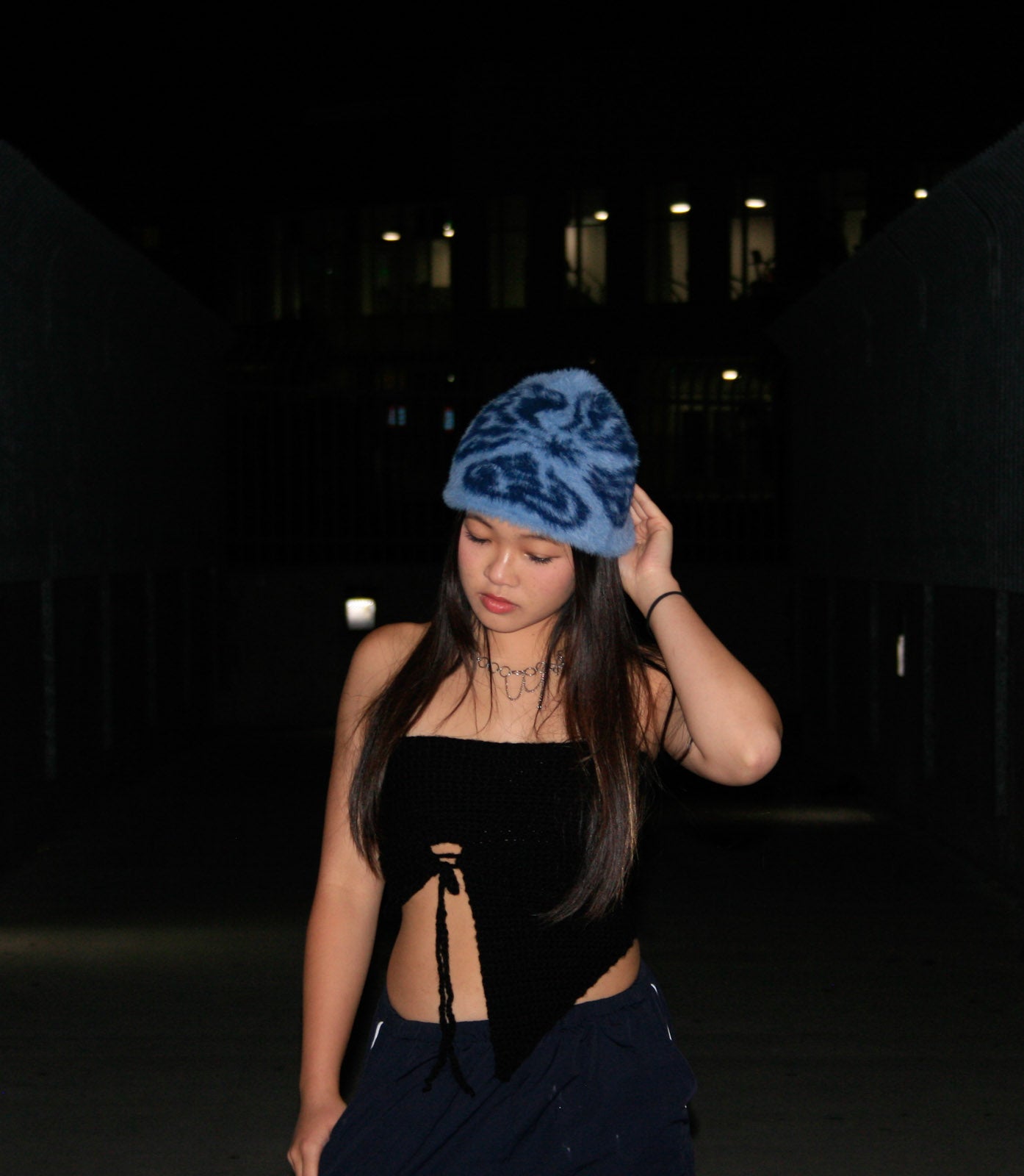 Female model wearing the Hypnotic Clothing Magnate blue mohair knit beanie at night, streetwear portrait.