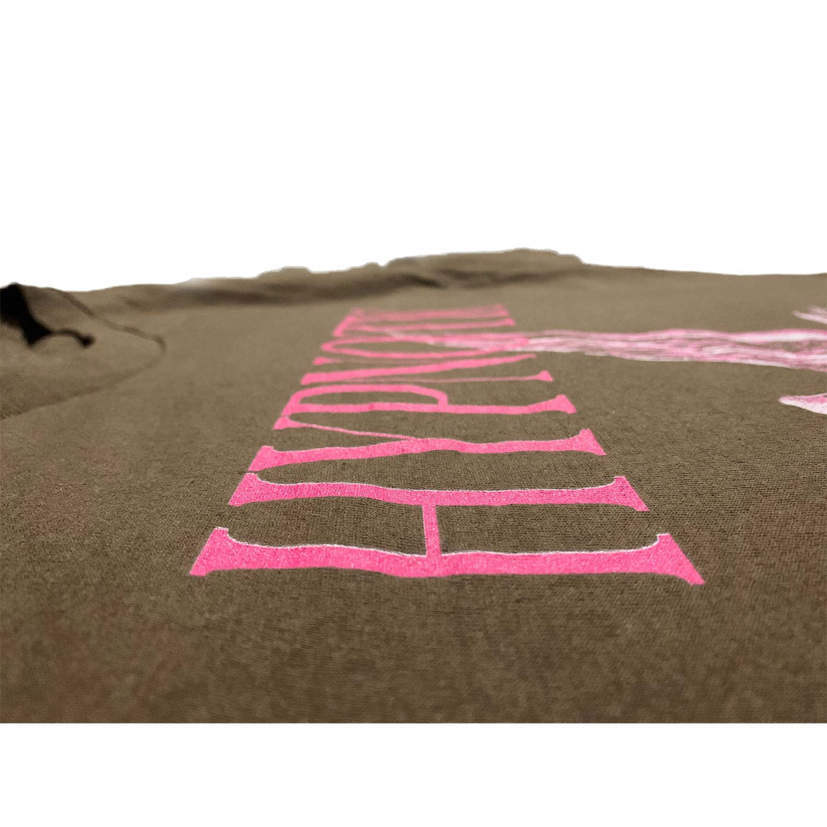 Detail shot of Hypnotic Clothing ‘Angel’ brown tee featuring distressed pink HYPNOTIC logo print.