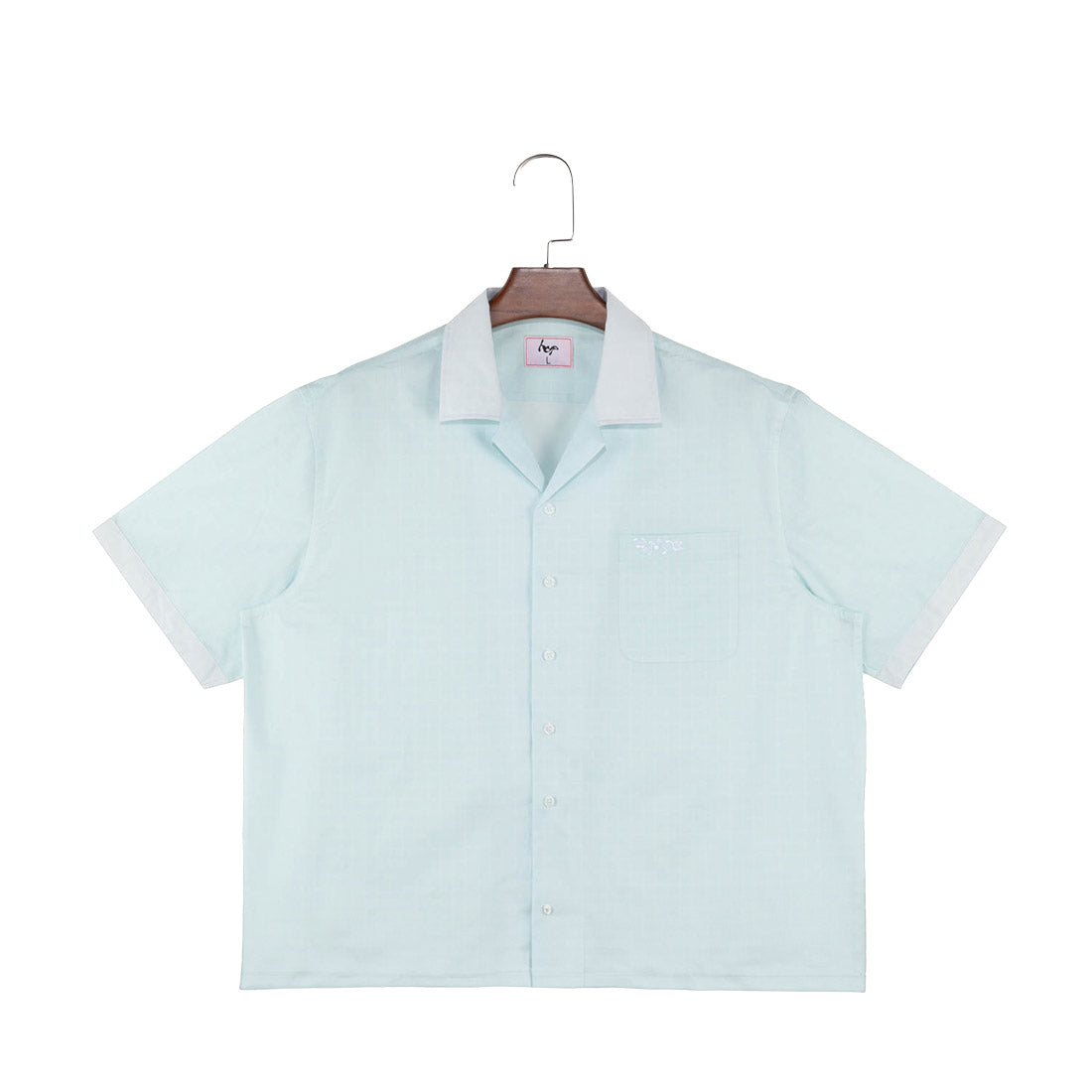 "hyp" short-sleeve button-up shirt hanging on wooden hanger against white background.